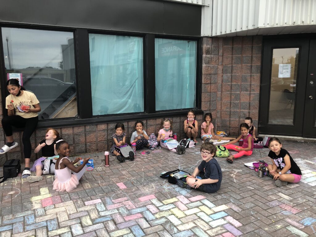 Children drawing with chalk at summer dance camp